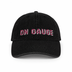 Black cap with 'ON GAUGE' text in pink on a white background