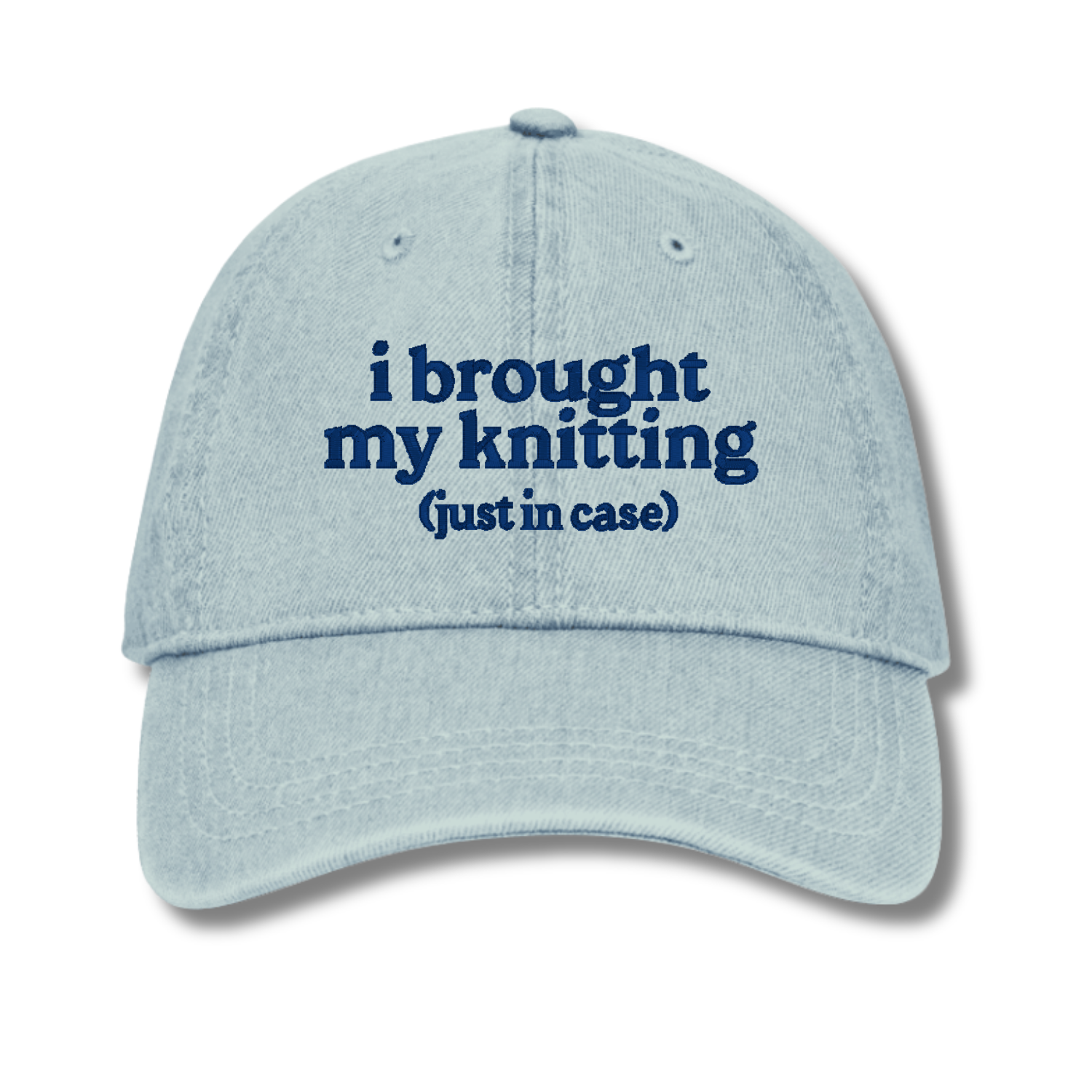 Light blue cap with text 'i brought my knitting (just in case)' on a white background