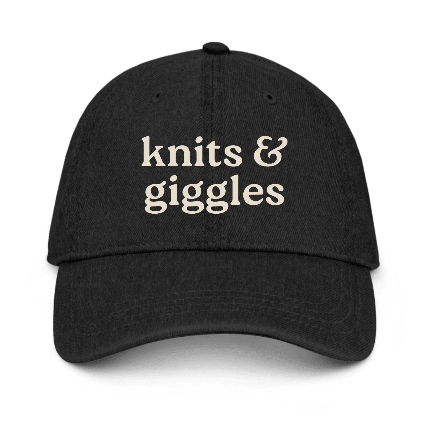 Black cap with 'knits & giggles' text on a white background