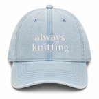 Light blue cap with 'always knitting' text on a white background