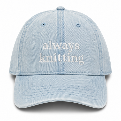 Light blue cap with 'always knitting' text on a white background
