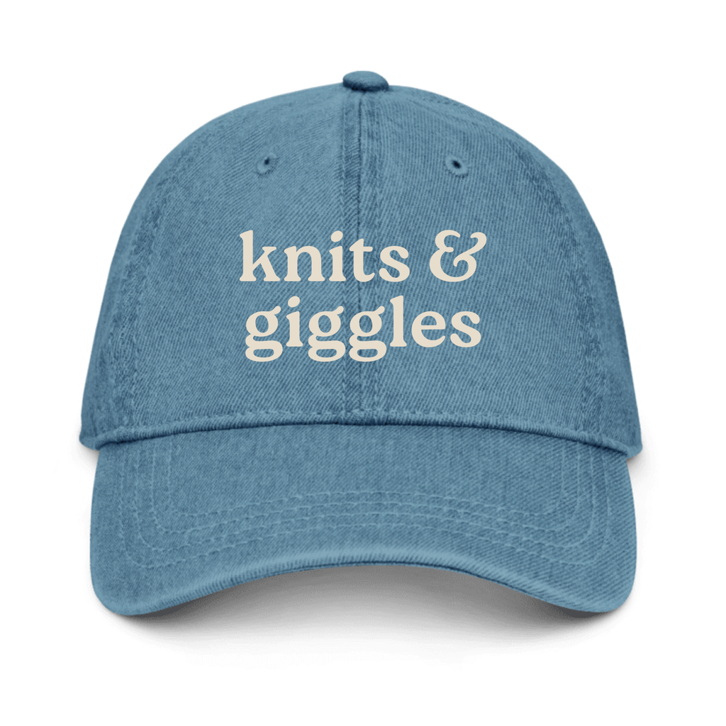 Blue cap with 'knits & giggles' text on a white background