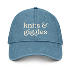 Blue cap with 'knits & giggles' text on a white background