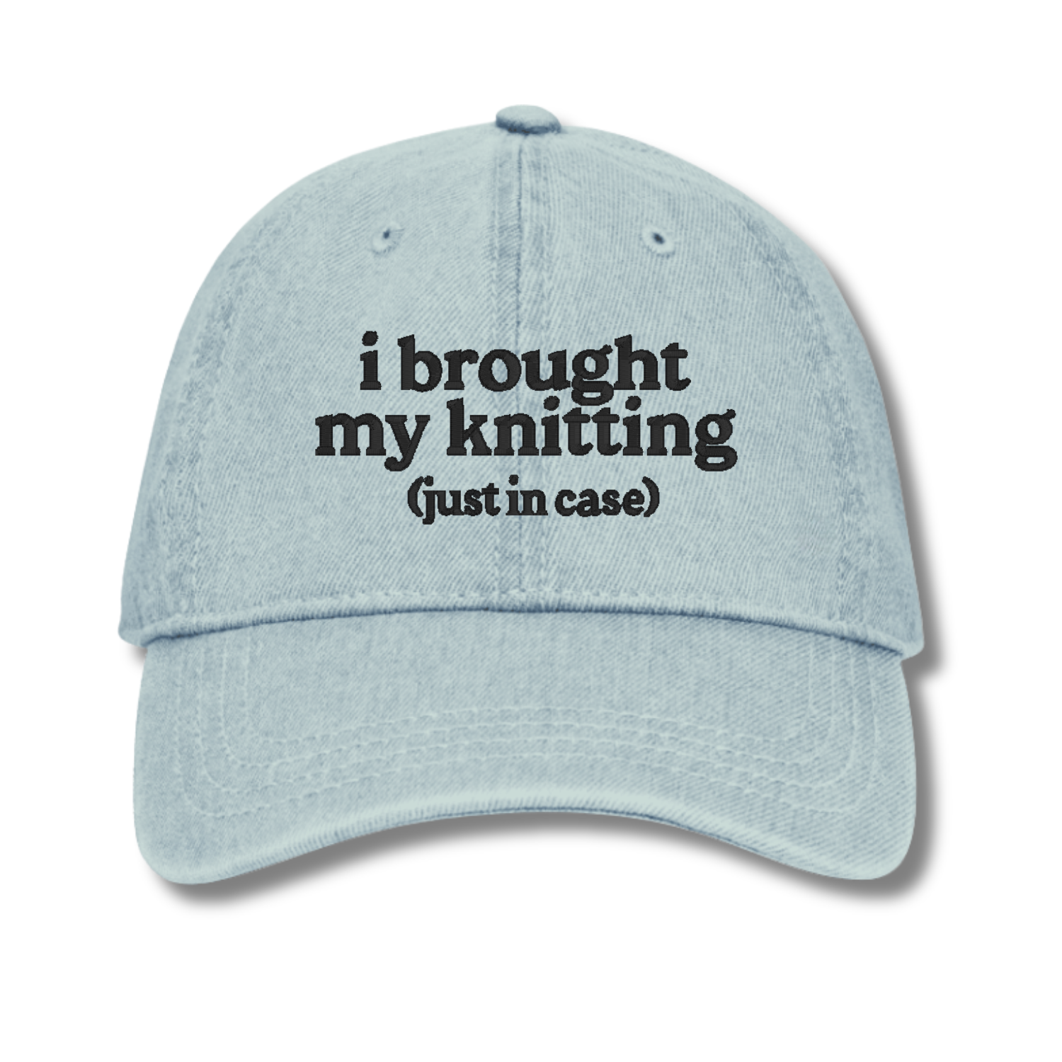 Light blue cap with text 'i brought my knitting (just in case)' on a white background