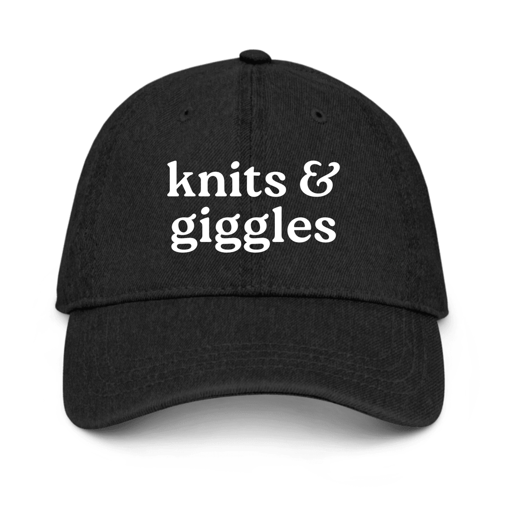 Black cap with 'knits & giggles' text on a white background