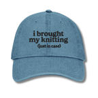 Blue cap with text 'i brought my knitting (just in case)' on a white background