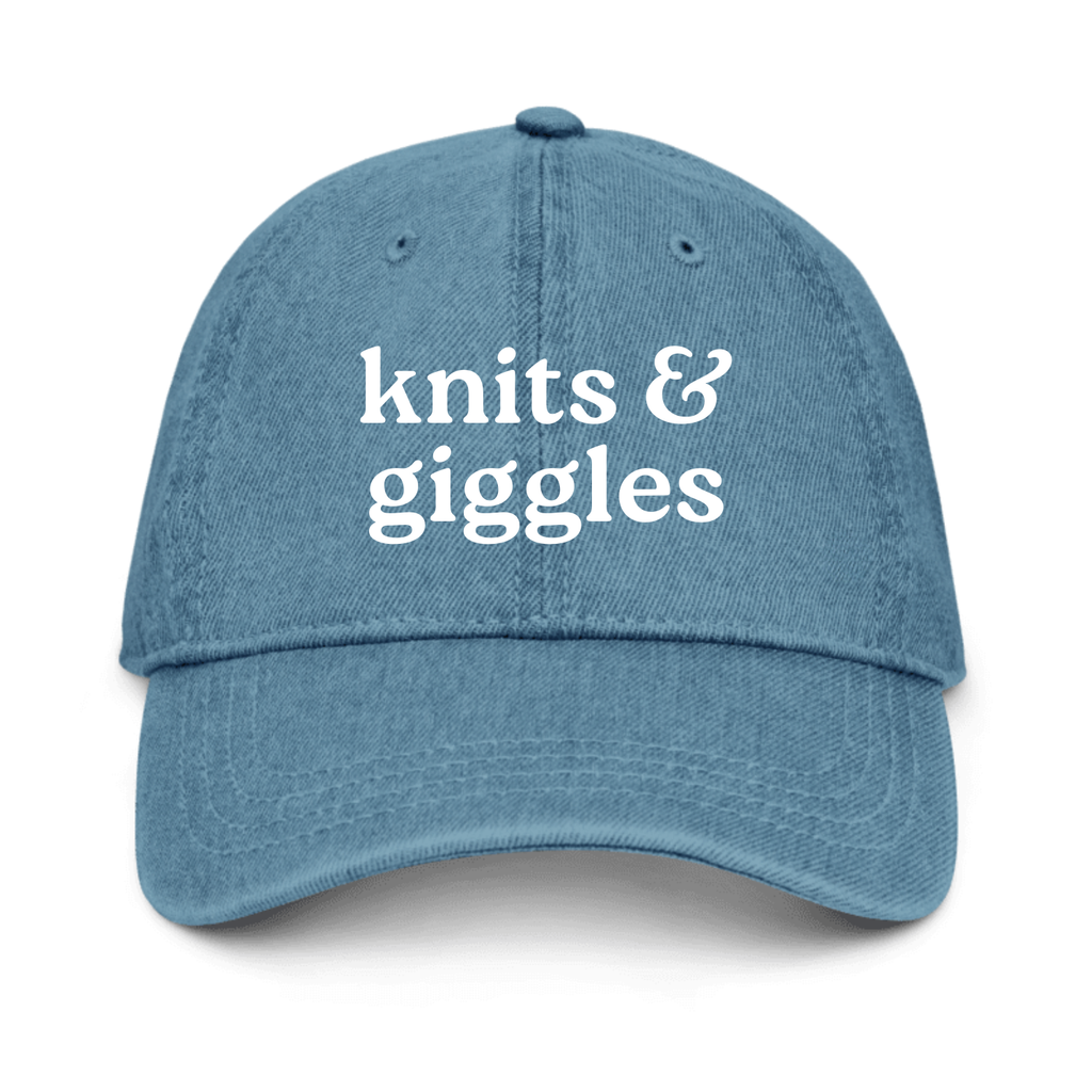Blue cap with 'knits & giggles' text on a white background