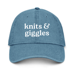 Blue cap with 'knits & giggles' text on a white background
