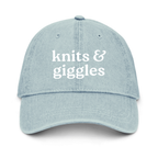 Light blue denim cap with 'knits & giggles' text on a white background