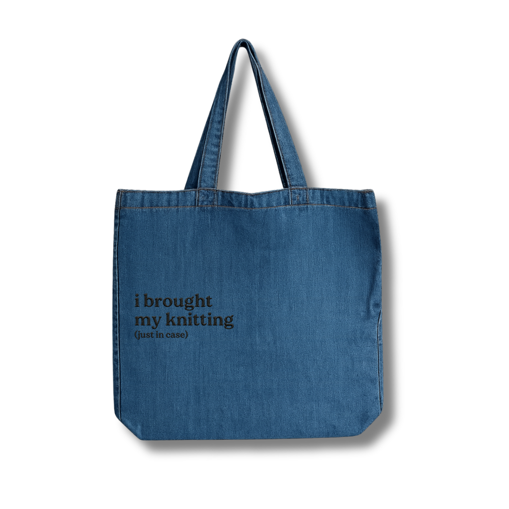 Blue denim tote bag with text on a white background