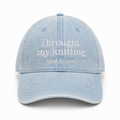 Light blue denim cap with white text on a white background