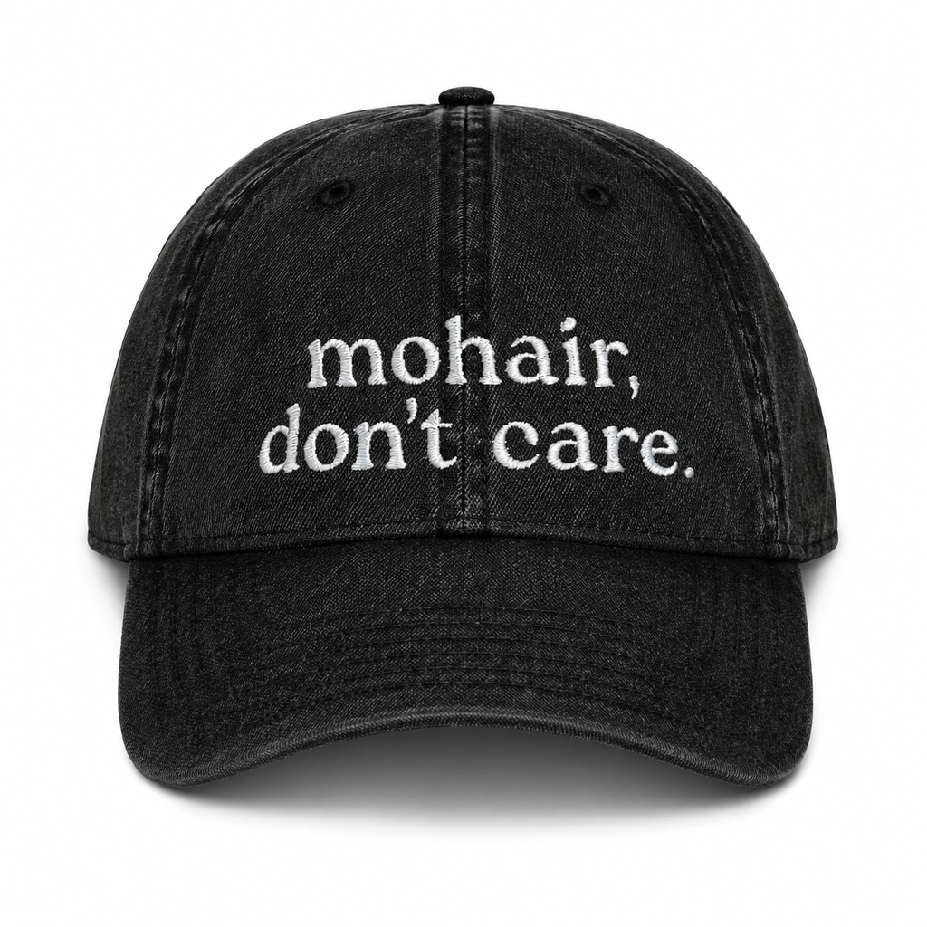 Black cap with 'mohair, don't care' text on a white background