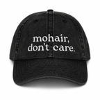 Black cap with 'mohair, don't care' text on a white background