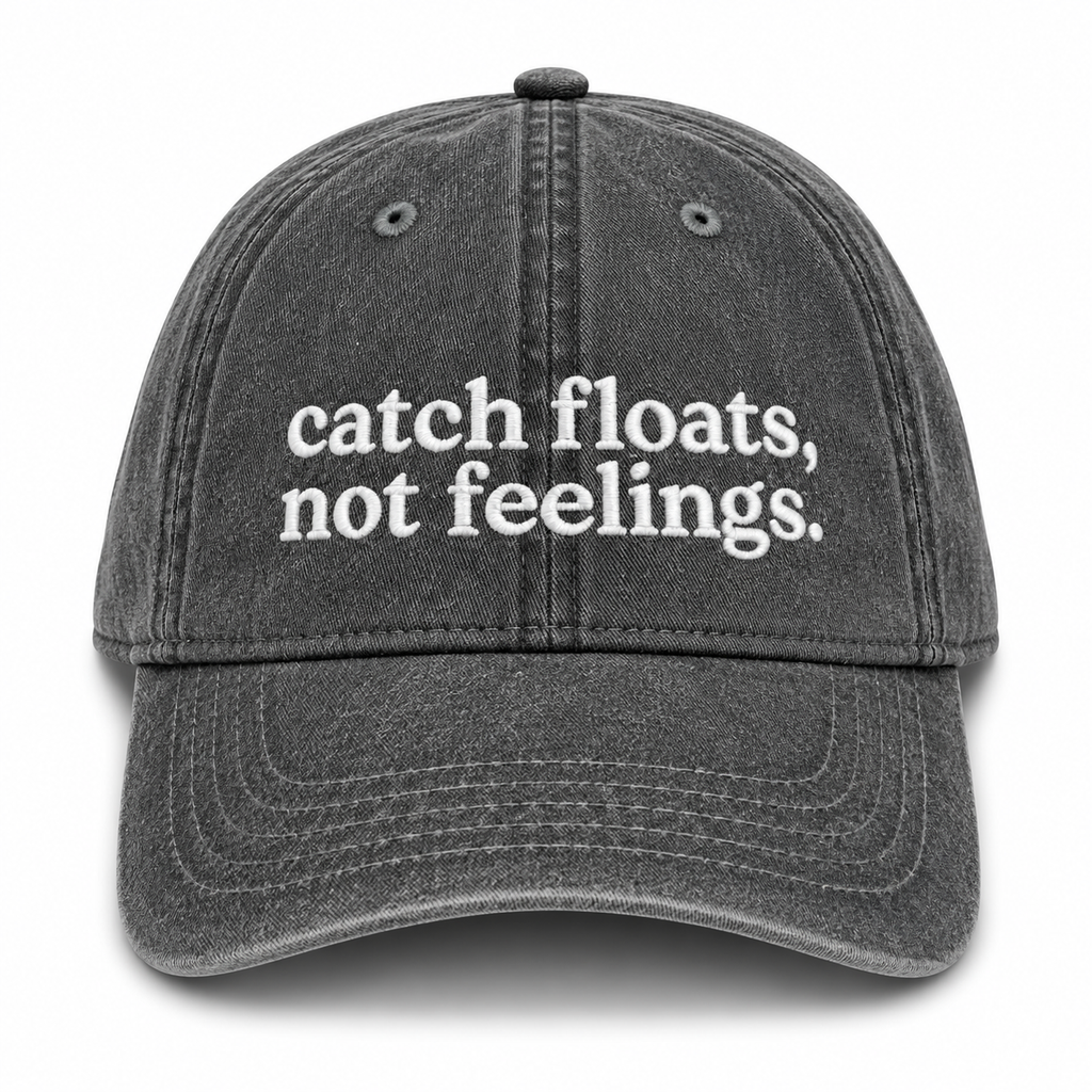 Black cap with 'catch floats, not feelings' text on a white background