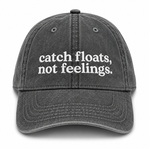 Black cap with 'catch floats, not feelings' text on a white background
