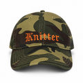 Camouflage baseball cap with 'Knitter' embroidery on a white background