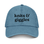 Blue cap with 'knits & giggles' text on a white background