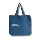 Blue tote bag with text 'i brought my knitting (just in case)' on a white background