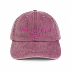 Pink denim cap with 'sleeve island local' text on a white background