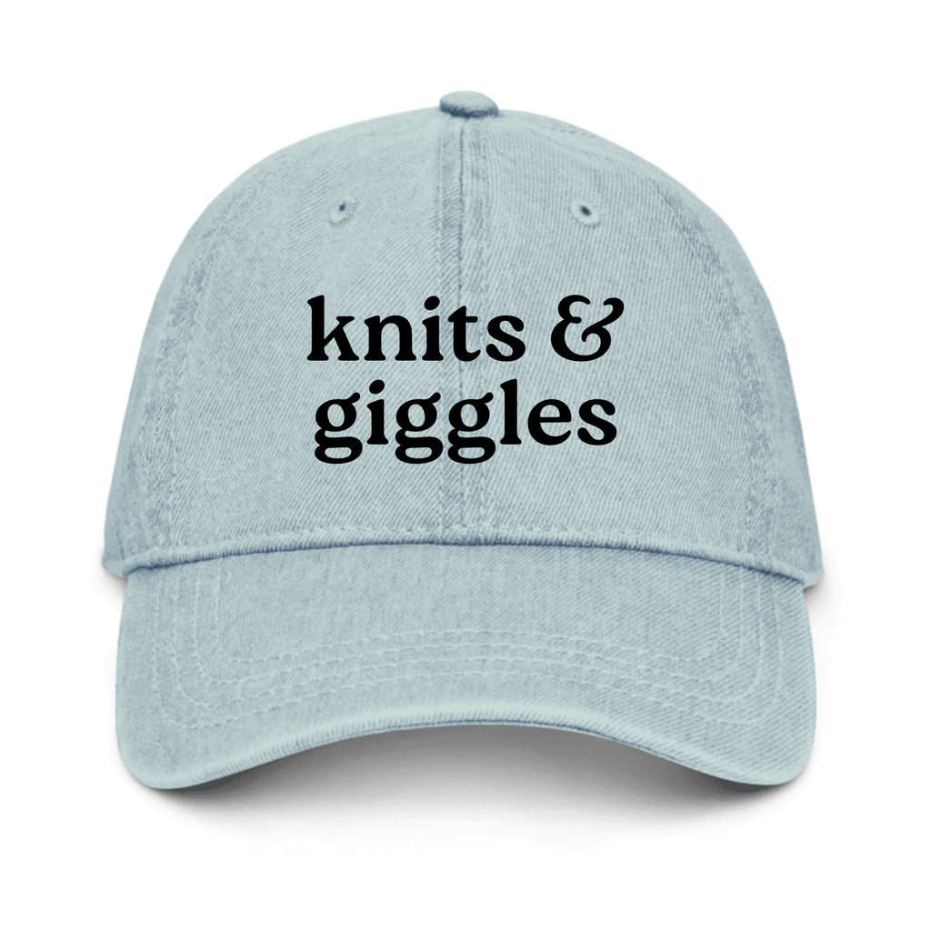 Light blue cap with 'knits & giggles' text on a white background