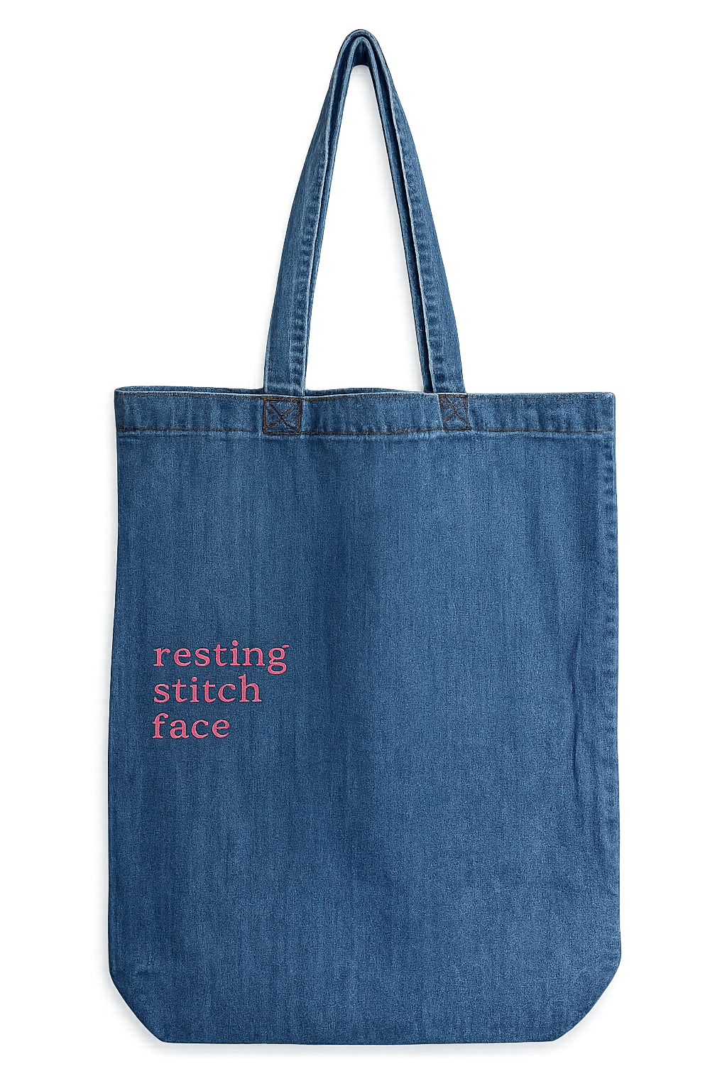 Blue denim tote bag with 'resting stitch face' text on a white background
