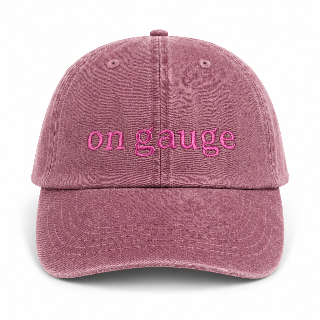 Pink cap with 'on gauge' text on a white background