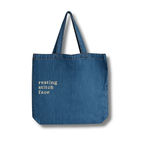 Blue tote bag with 'resting stitch face' text on a white background