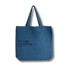 Blue denim tote bag with text on a white background
