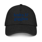 Black cap with a blue embroidered design on a white background