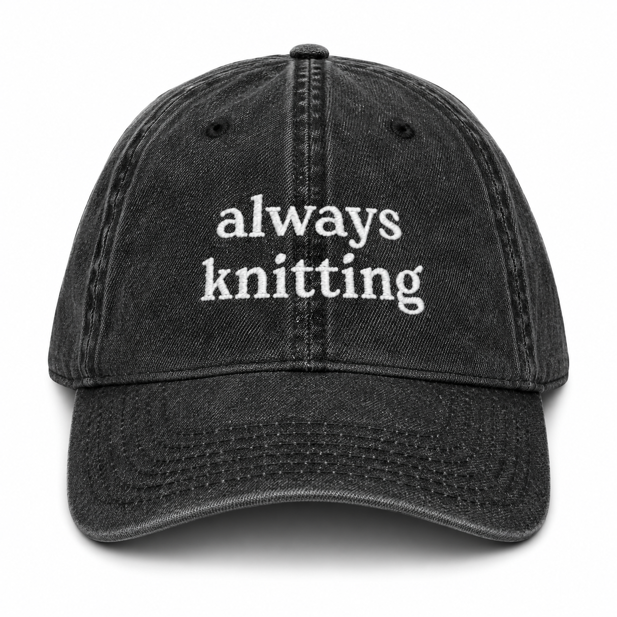 Black cap with 'always knitting' text on a white background