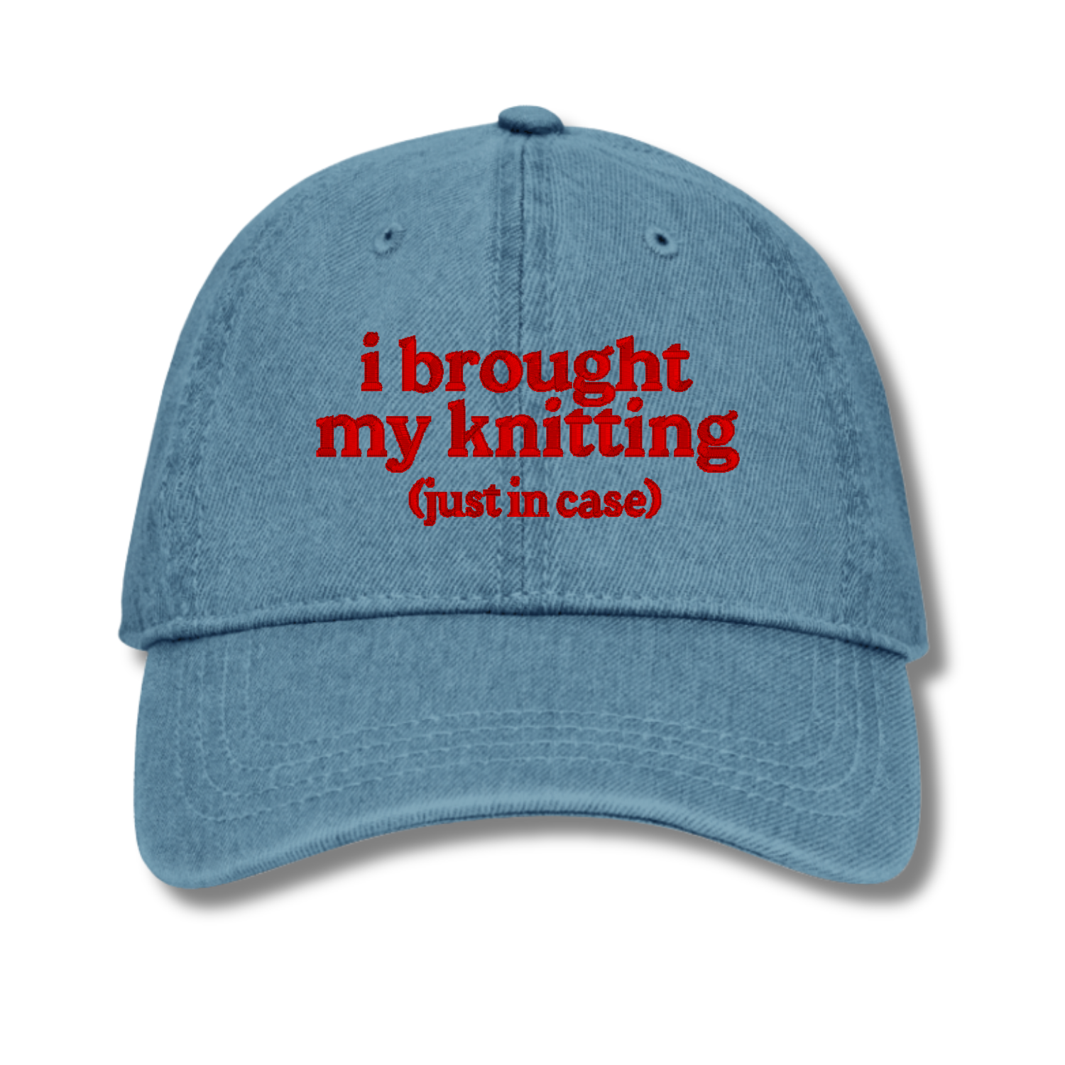 Blue cap with red text 'i brought my knitting (just in case)' on a white background