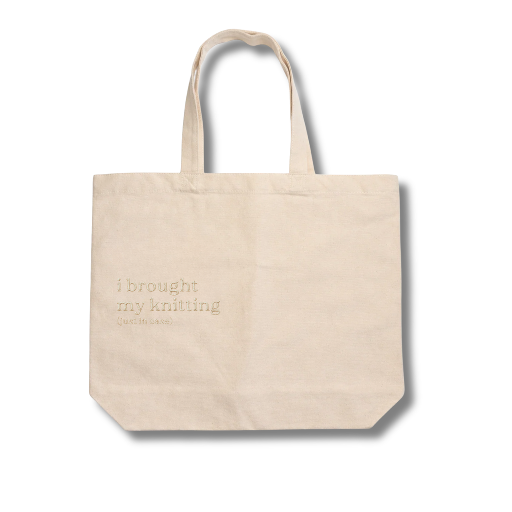 Beige tote bag with text on a white background