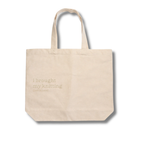 Beige tote bag with text on a white background