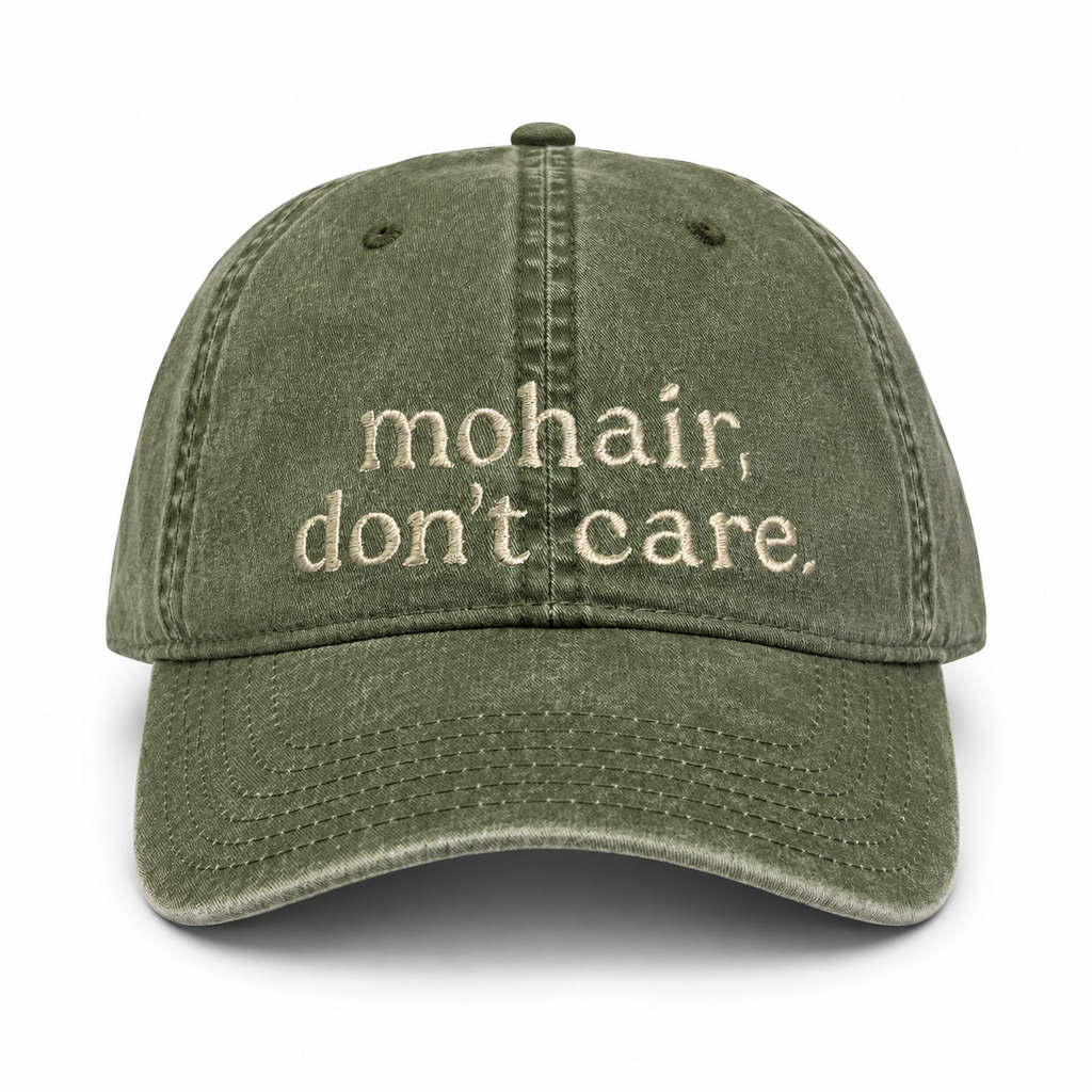 Green cap with 'mohair, don't care' text on a white background
