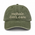 Green cap with 'mohair, don't care' text on a white background