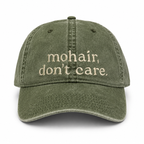 Green cap with 'mohair, don't care' text on a white background