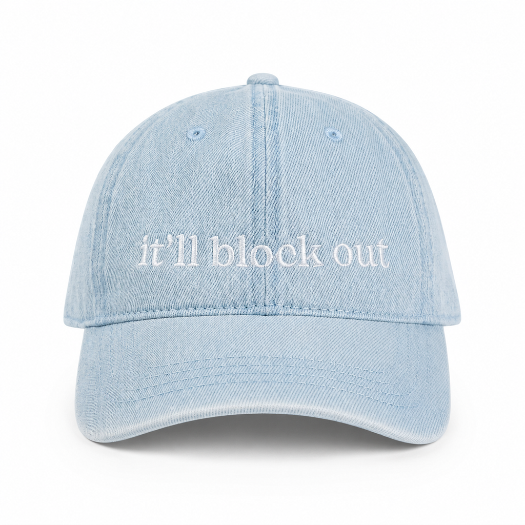 Light blue denim cap with 'it'll block out' text on a white background