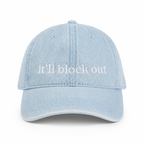 Light blue denim cap with 'it'll block out' text on a white background