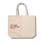 Beige tote bag with red text 'i brought my knitting (just in case)' on a white background