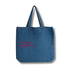 Blue denim tote bag with pink text on a white background
