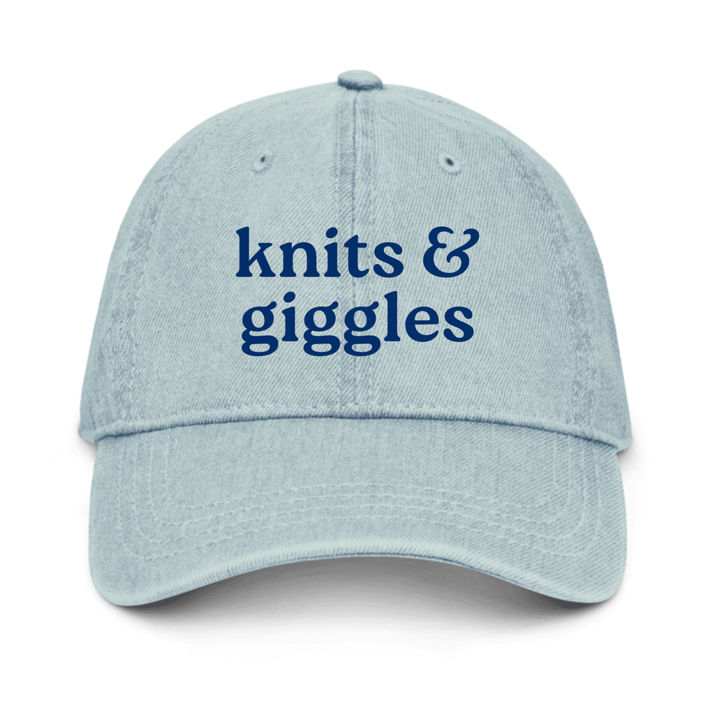 Light blue cap with 'knits & giggles' text on a white background