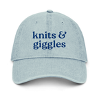 Light blue cap with 'knits & giggles' text on a white background