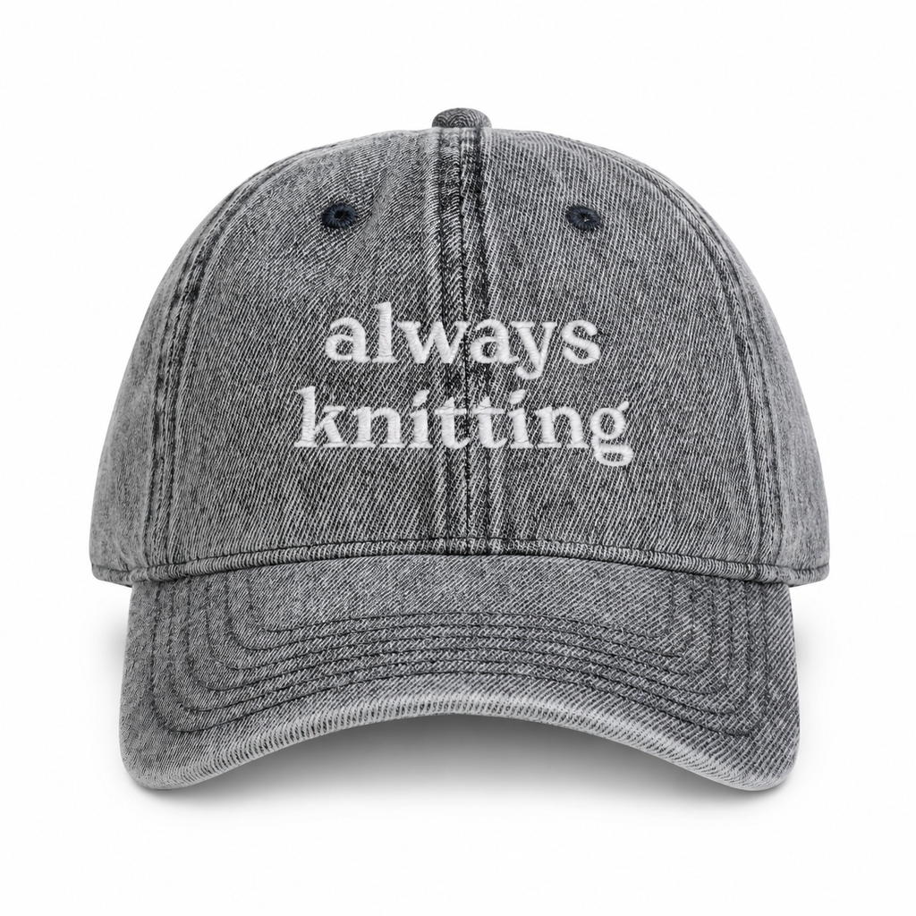 Gray cap with 'always knitting' text on a white background
