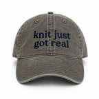 Gray cap with 'knit just got real' text on a white background