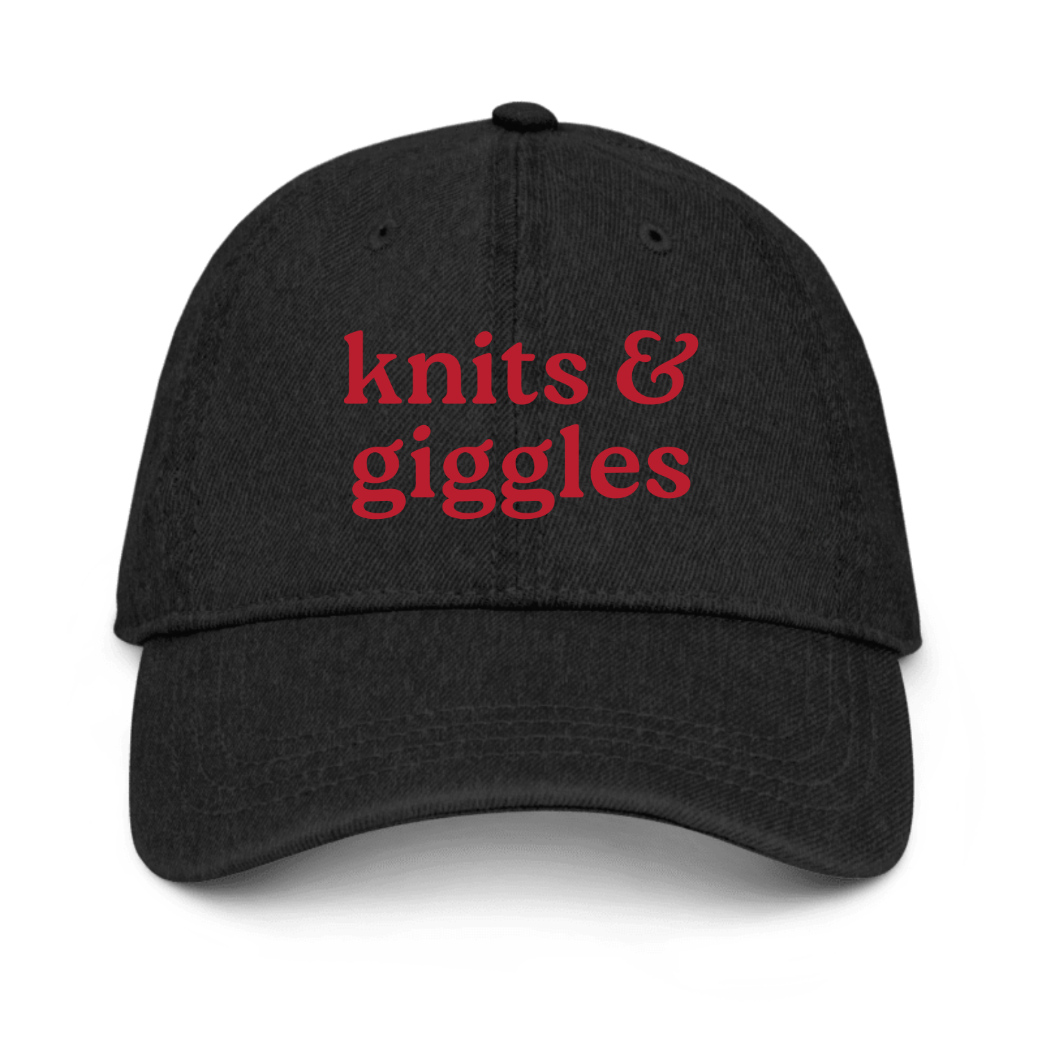 Black cap with 'knits & giggles' text in red on a white background