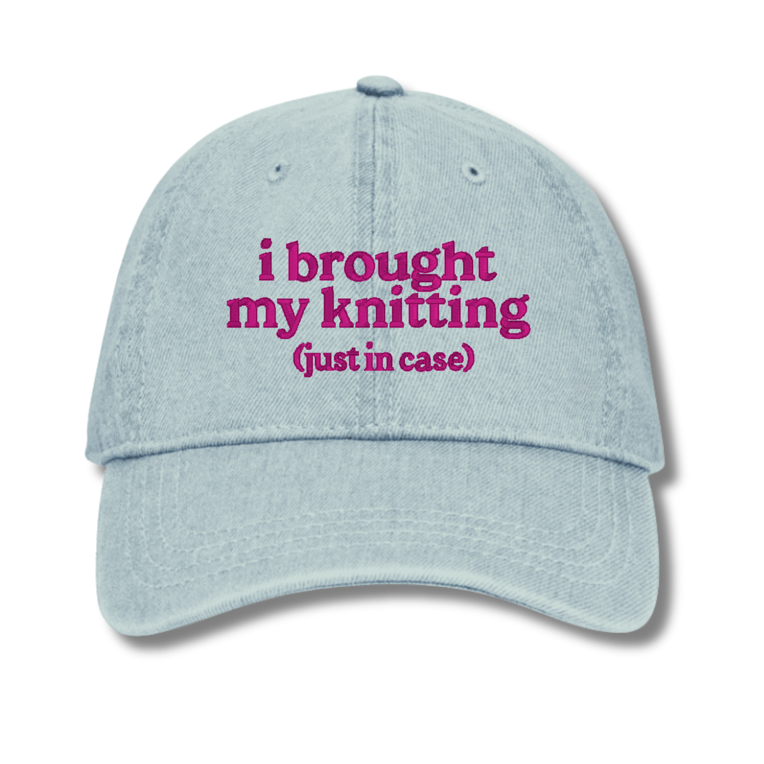 Light blue cap with pink text 'i brought my knitting (just in case)' on a white background