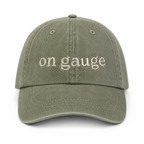 Green cap with 'on gauge' text on a white background
