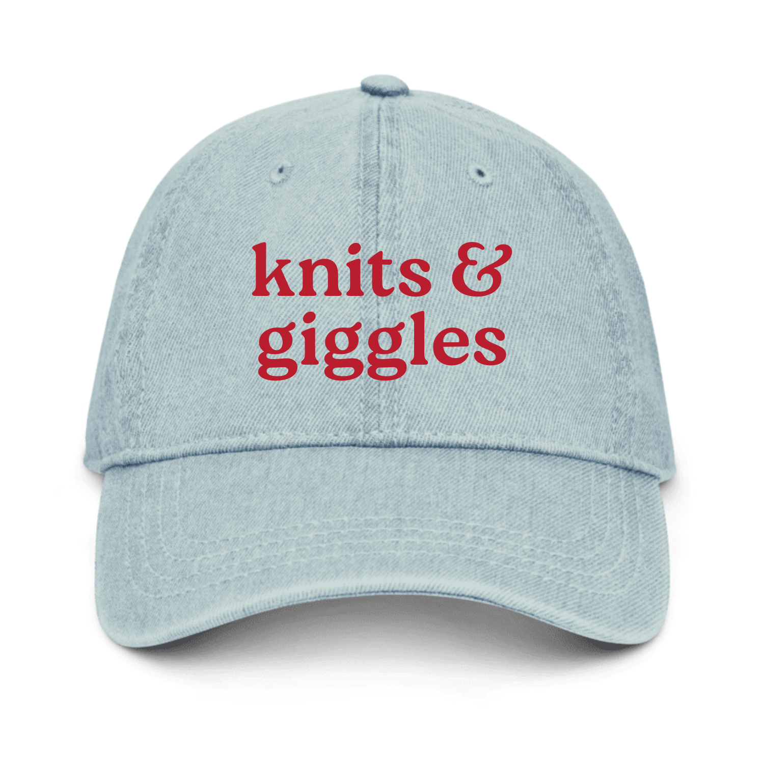 Light blue cap with 'knits & giggles' text in red on a white background