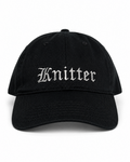 Black cap with 'Knitter' embroidered on a white background