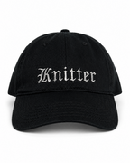 Black cap with 'Knitter' embroidered on a white background